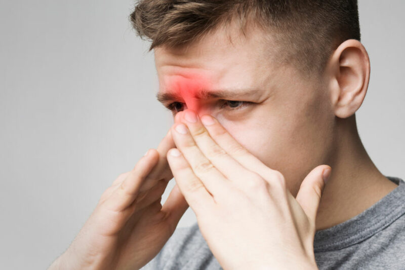 person experiencing sinus pain