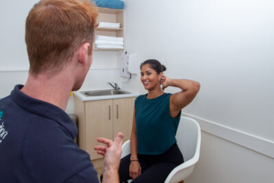 practitioner consulting patient for neck pain