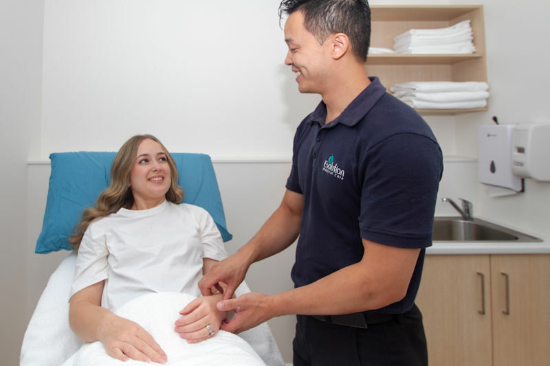acupuncturist taking pulse of fertility patient thumbnail