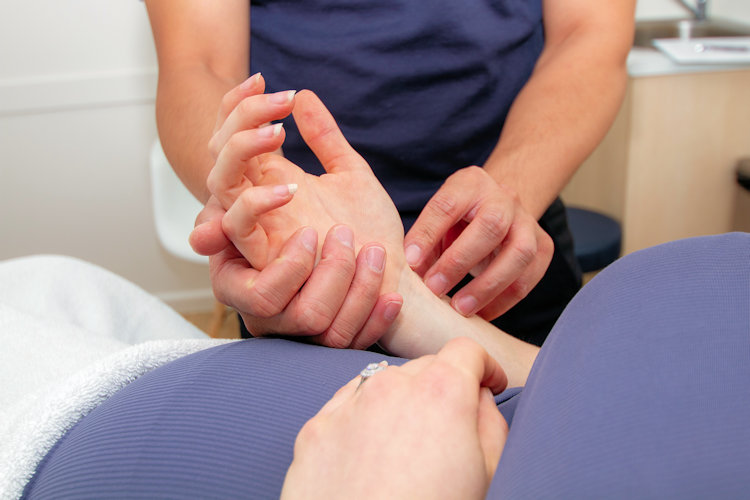 acupuncturist taking pulse of patient