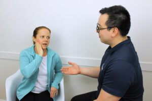 practitioner consulting patient with tmj pain