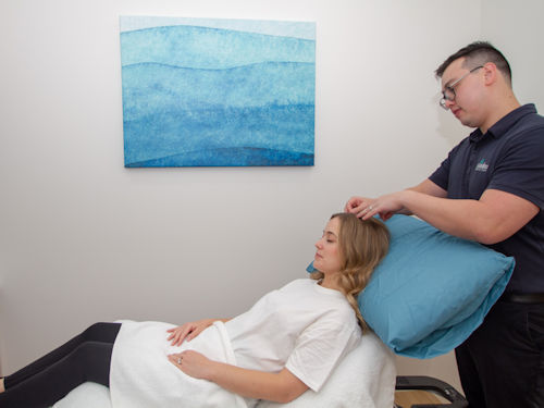 practitioner providing acupuncture treatment for fertility