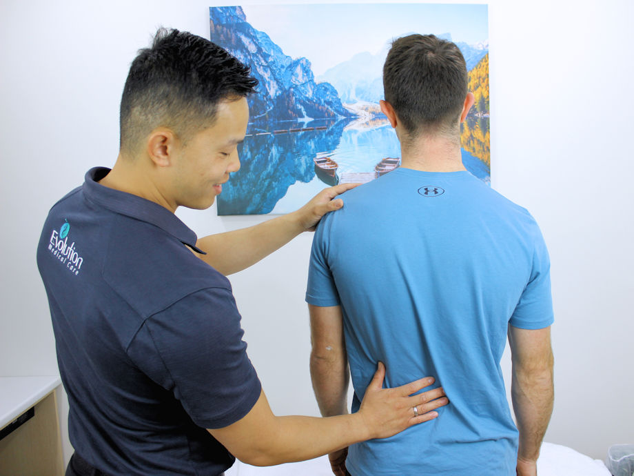 Patient being assessed by a practitioner for a bulging disc