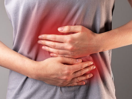 person experiencing digestive issues due to chronic stress