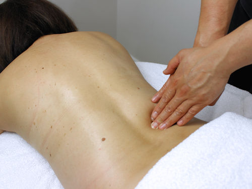 patient receiveing massage therapy to relive tight muscles to prevent headaches