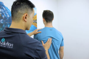 Patient being assessed by practitioner for best natural solutions to help back pain