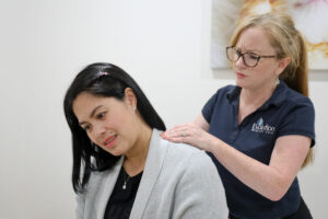 practitioner assessing patient for neck pain