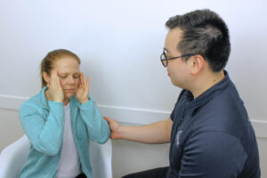 practitioner providing support to patient who suffers from migraines