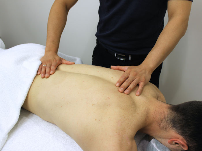 patient having assessment and begining natural treatments to reduce back pain