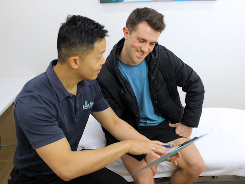 Patient consulting with practitioner as to the best therapy to help alleviate pain