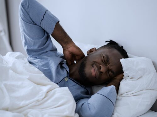 Man suffering with pain unable to sleep