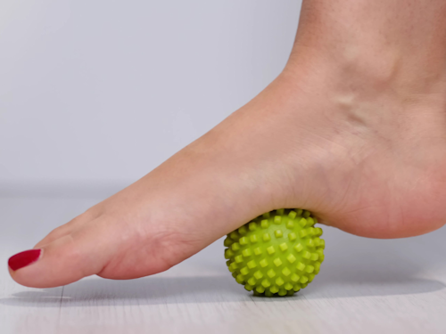 person excercising with a trigger point ball to help alleviate platar fasciitis pain
