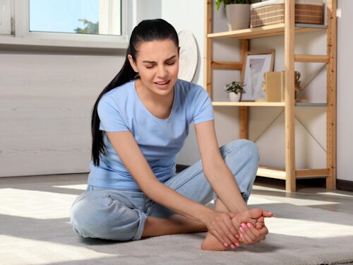 woman suffering with foot pain from plantar fasciitis