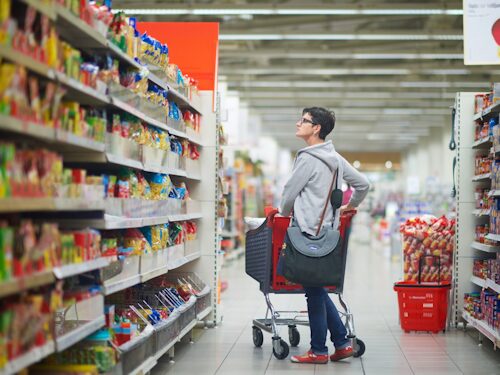 lady in supermarket shopping for convenience processed foods