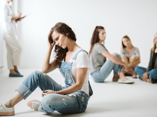 woman suffering with chronic pain which is affecting her mental health and making her socially isolated