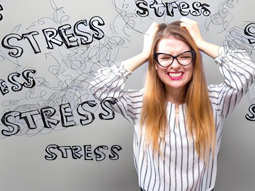 woman showing signs of stress which is impacting her mental and physical well-being