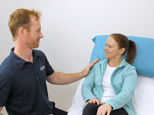 woman consulting with practitioner to discuss personalised treatment options to alleviate chronic pain and improve mental health