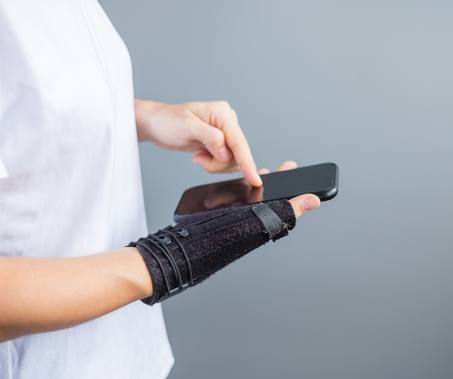 persona wearing a support for their wrist during carpal tunnel syndrome