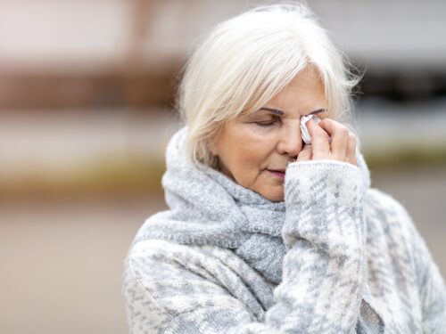 women experiencing excessive tearing of her eye as a result of bells palsy