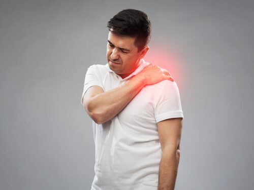 man with pain from frozen shoulder unable to move arm
