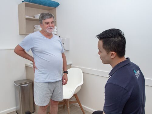 man seeking assessment for his ongoing chronic lower back pain