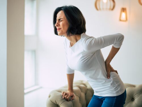 woman experiencing estricted movement from lower back pain