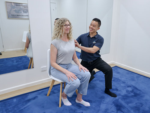 woman getting advice from practitioner on strengething her back and core to alleviate lower back pain