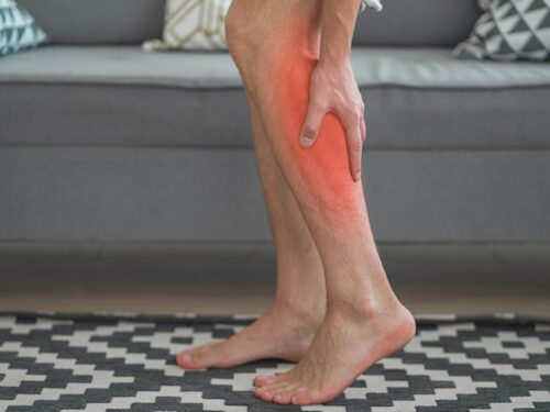 man experiencing cramping, muscle tightness and soreness or pain due to magnesium deficiency
