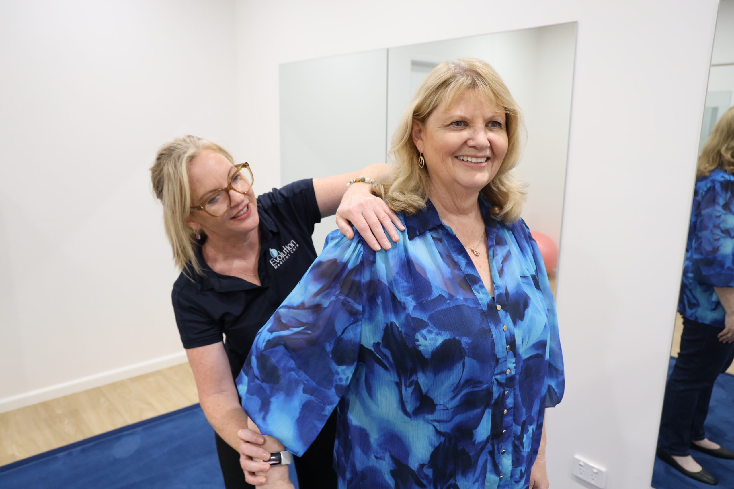 Practitioner checking shoulder mobility with a Home Care Package client